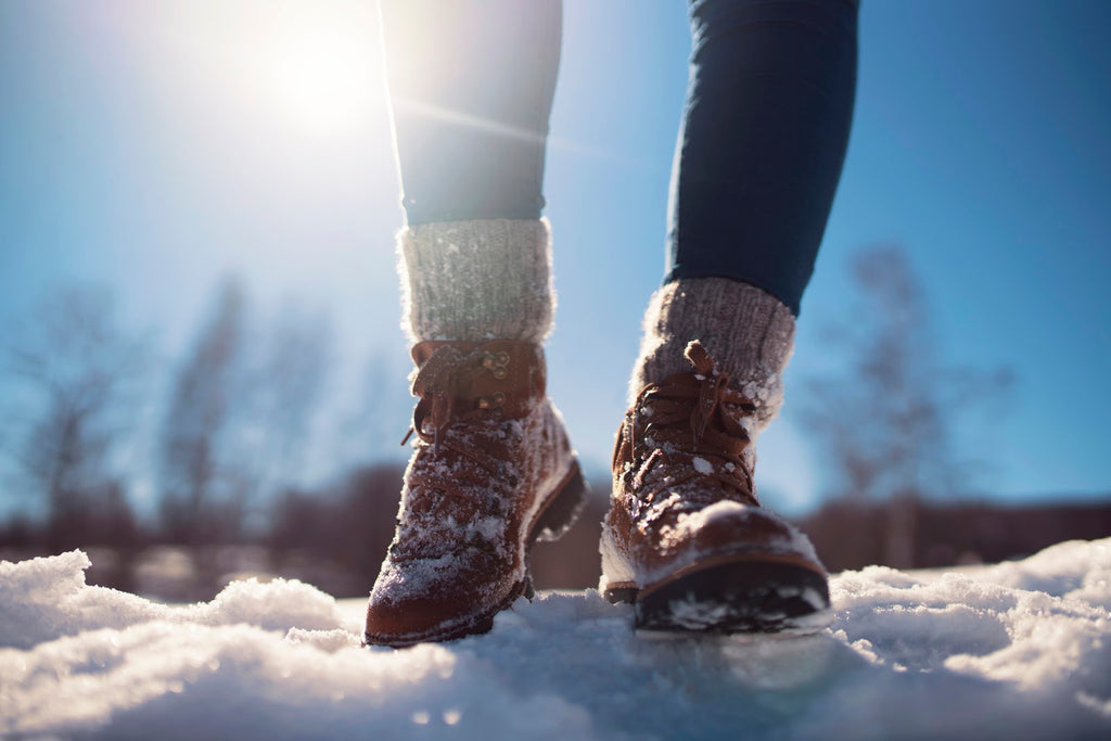 woman hiking in the snow wearing merino wool socks