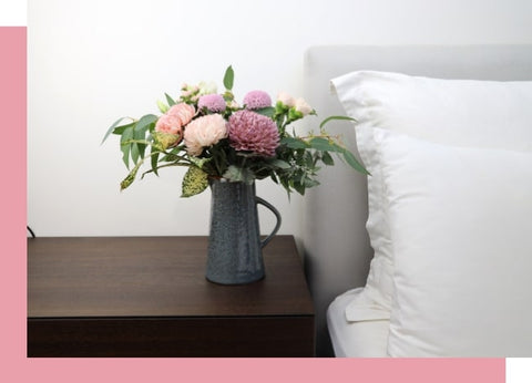 flowers in vase on bedside table
