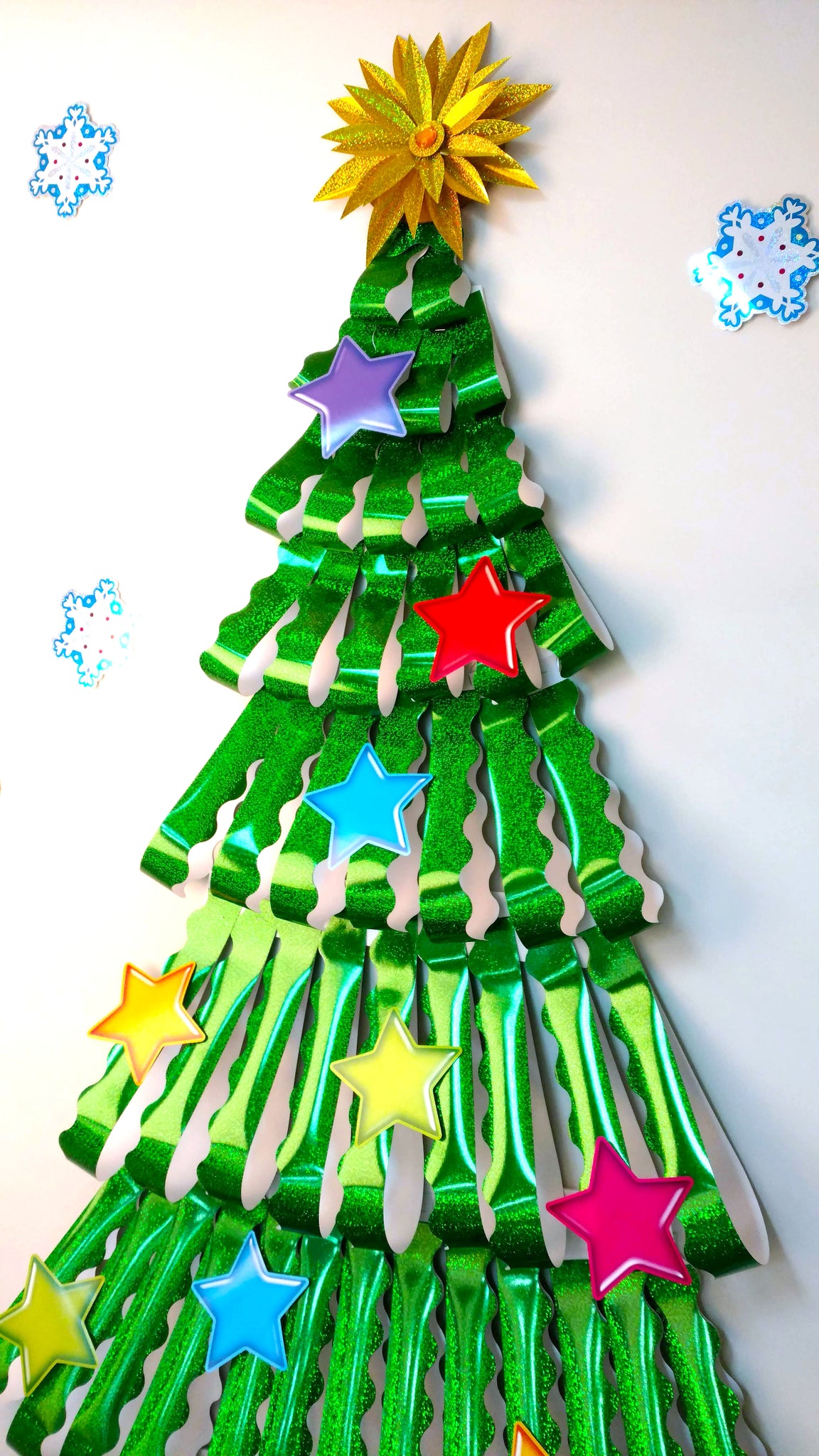 DIY Christmas tree wall decoration made from paper sparkle trimmers.