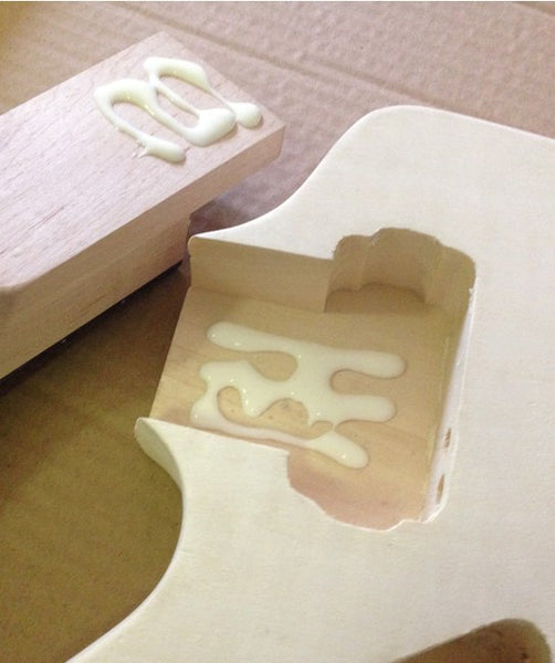 Neck of kit guitar with glue applied