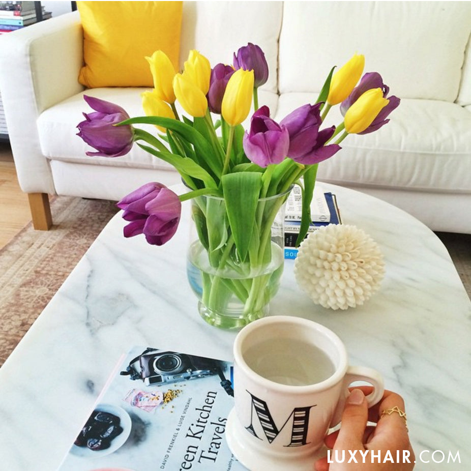 Mug With Water On A Table With Tulips