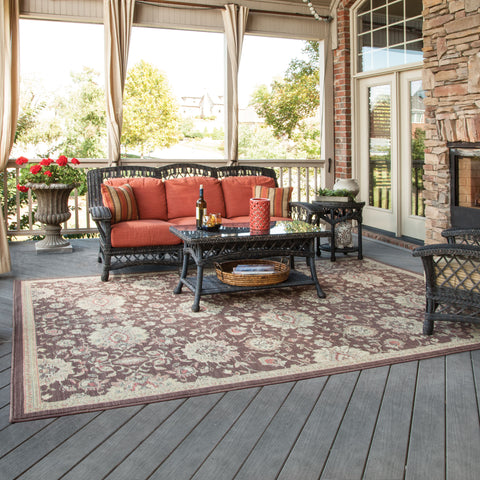 outdoor patio space with large rug under furniture setting.