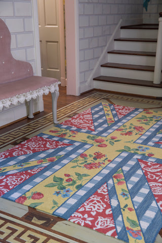 floral rug at the foot of a country cottage stairs.