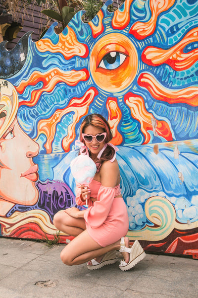 Colorful mural and cotton candy and 1940's fashion