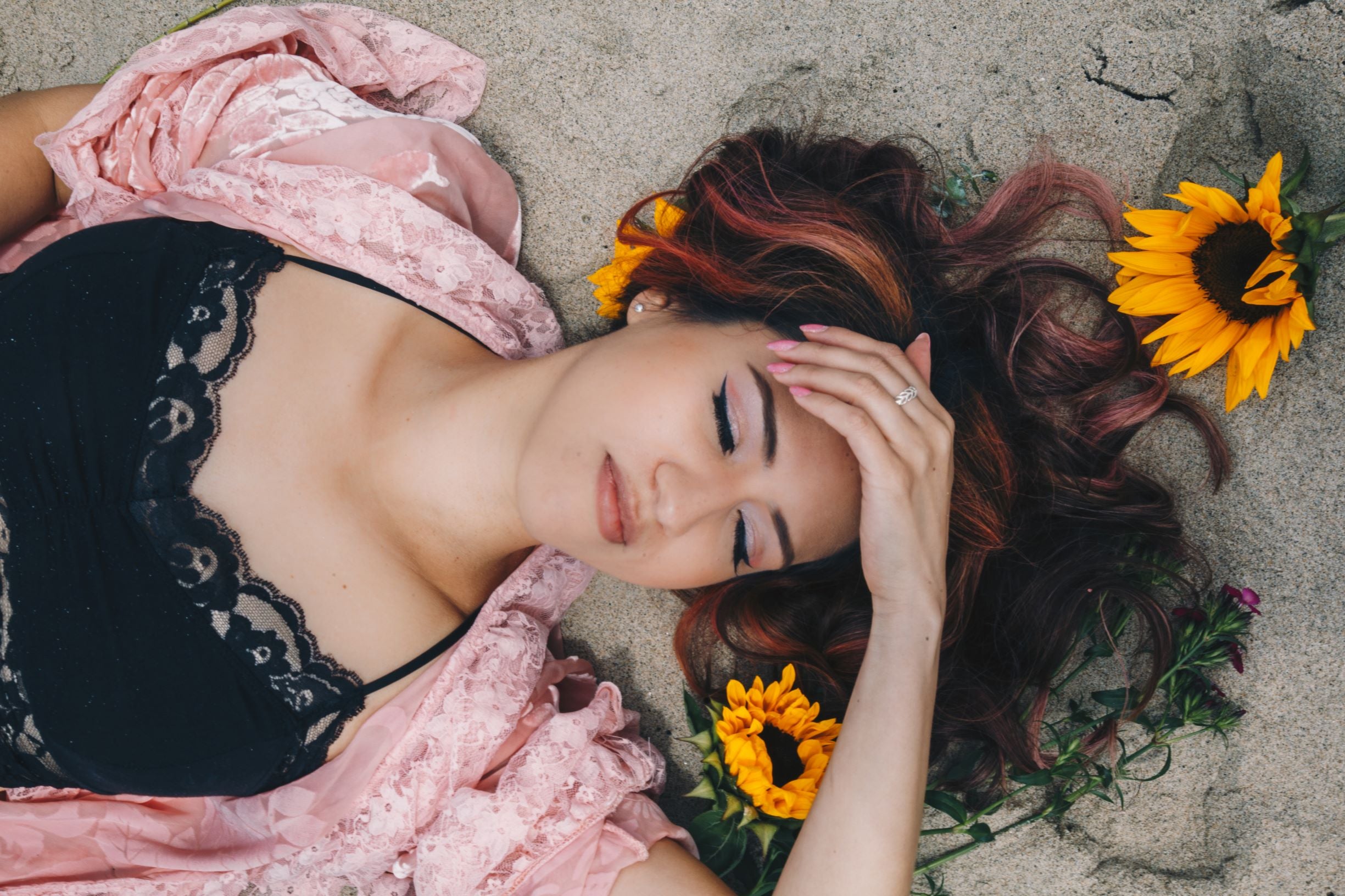 Girl with flowers in her pink hair and lace duster and lace bralette at Venice Beach 