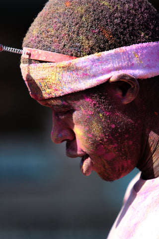 A side view image of a man with paint in face