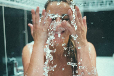 Woman Splashing Water On Face