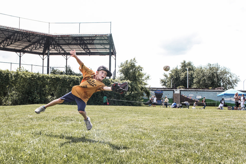 Warstic Woodmen's bat boy going for the sports center catch