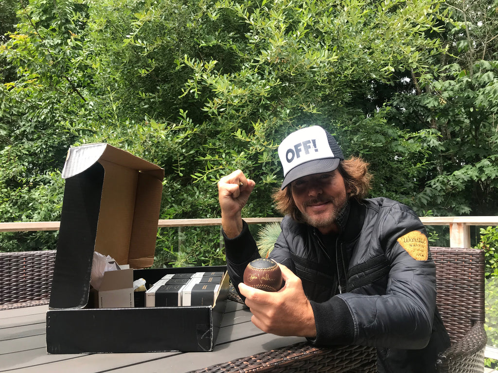 Eddie Vedder signing the auction baseballs.