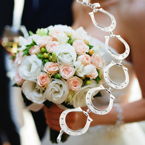 Bride wearing solid silver designer horseshoe bracelet