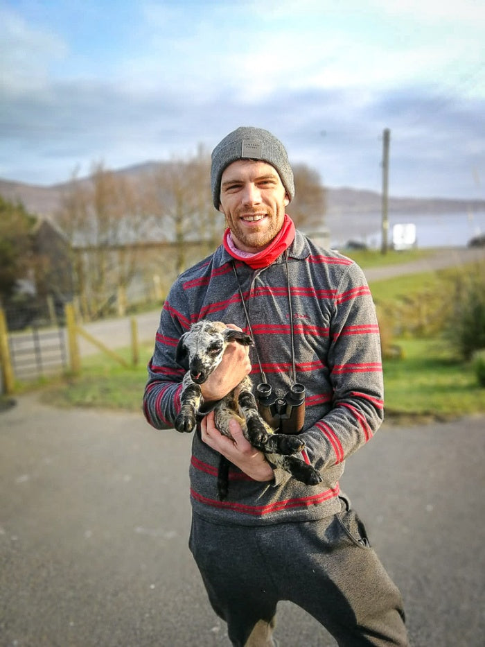 Chris Thomson getting hands-on with the lambing season.