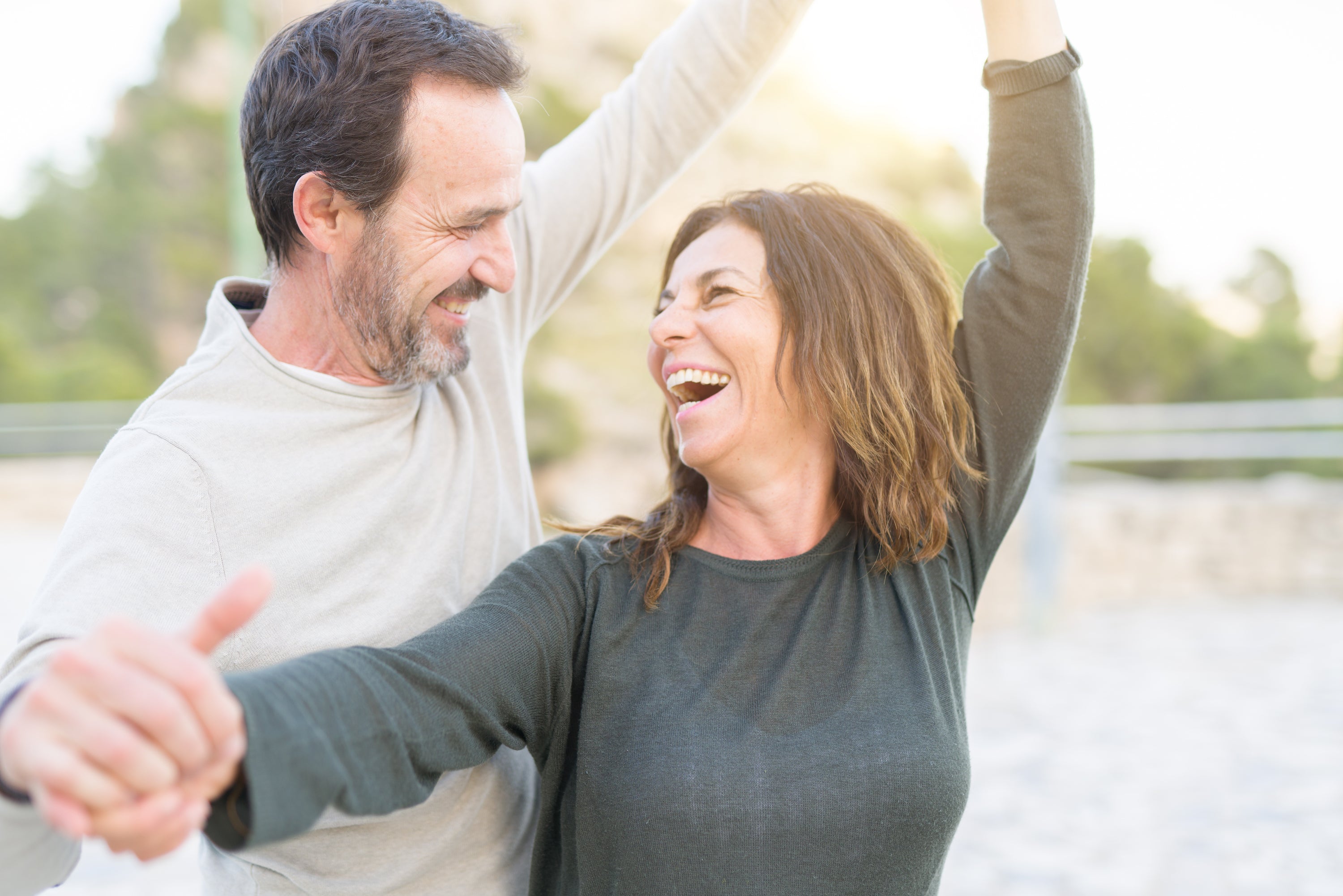 middle-aged couple laughing and dancing