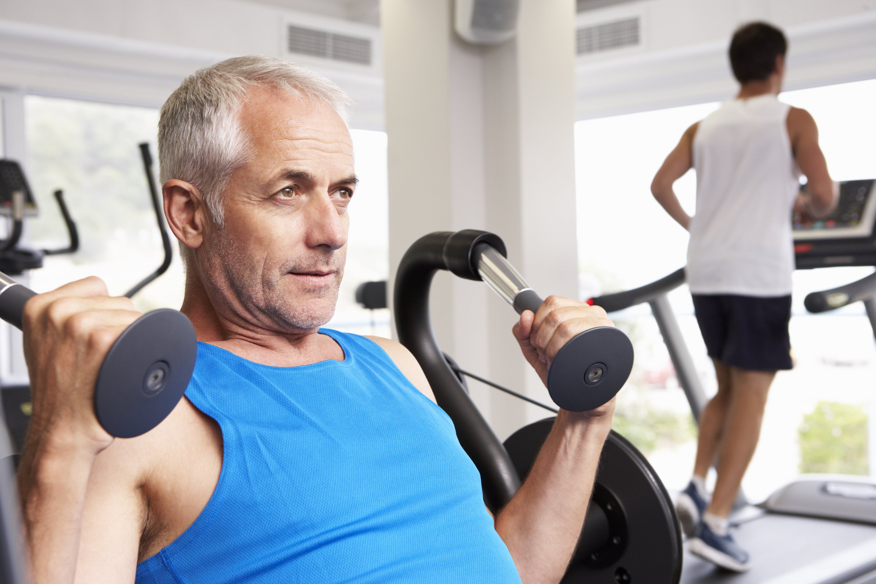 older man lifting dumbbells