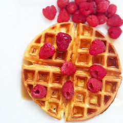 waffle with raspberries and syrup