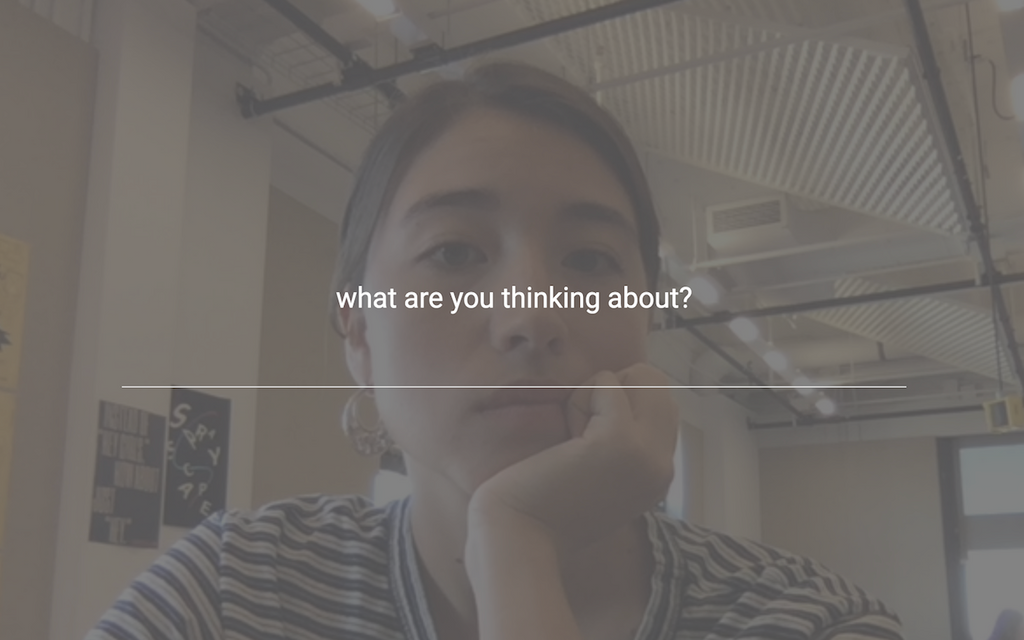 A screenshot of the Glance Back extension, featuring an image of the user looking at themselves with a question on the screen that prompts an answer: "what are you thinking about?"