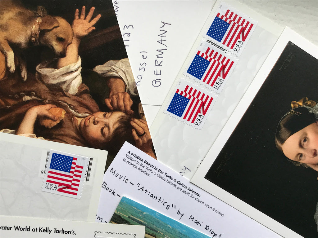 An image of an array of postcards and envelopes overlapping one another.