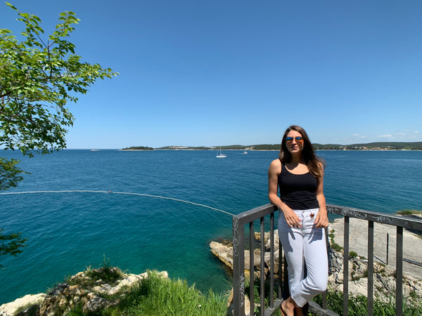 Woman standing by Adriatic Sea in Rovinj, Croatia