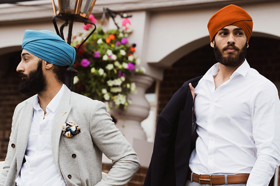 two sikh men wearing turbans in formal attire