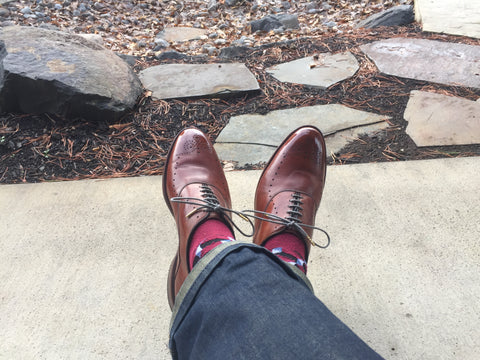 Back-view of mirror-shined AE Weybridges, Denim, and burgundy socks