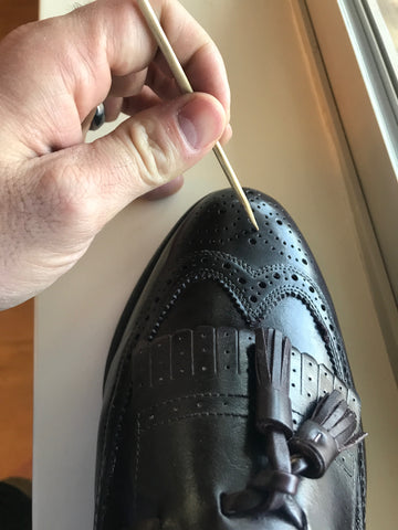 Cleaning out the shoe medallion with a shishkebab skewer