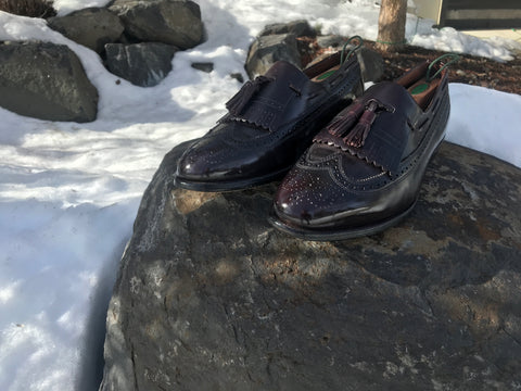 Beautiful Allen Edmonds Arlington Loafers on a rock in the snow