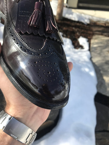 Andy holding an Allen Edmonds Arlington Loafer mirror shined toe