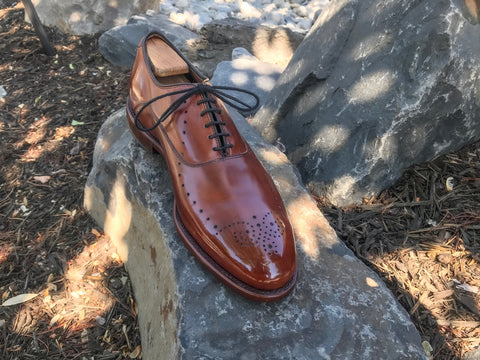 Single Allen Edmonds Weybridge in Walnut front on rocks mirror polished with All Natural Non-Toxic Pure Polish Products