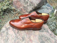 Mirror Shined Allen Edmonds Walnut Weybridge on a rock profile