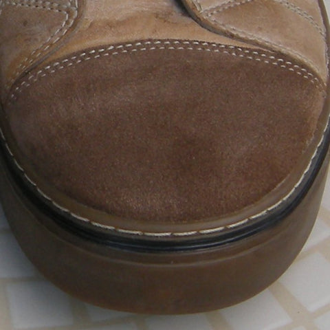 Damp suede toe cap of a boot