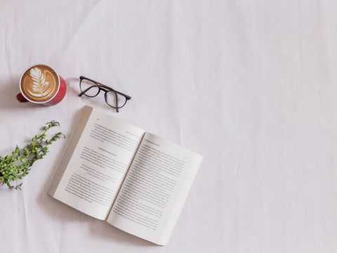 book, glasses, coffee on white background