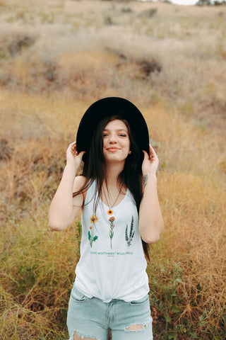 Graphic Style Tank top with Pacific Northwest Wildflowers on the front. Cute Wide Brim Hat. Field. Summer time. Golden Hour. Wearing white tank tops with jeans and jeans shorts. Summer time. Wenatchee, Washington. PNW Style. Pacific Northwest. Mountains. Mountain Style.