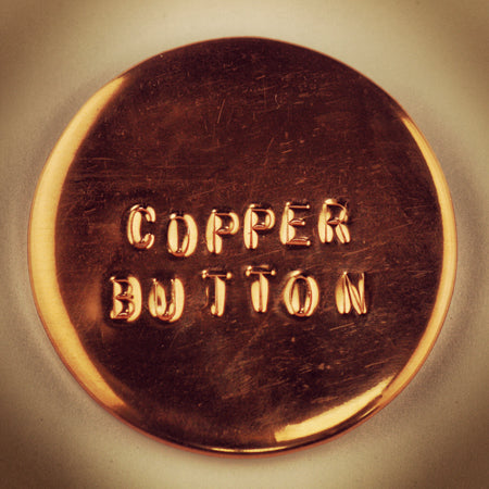 embossed copper pin-back button