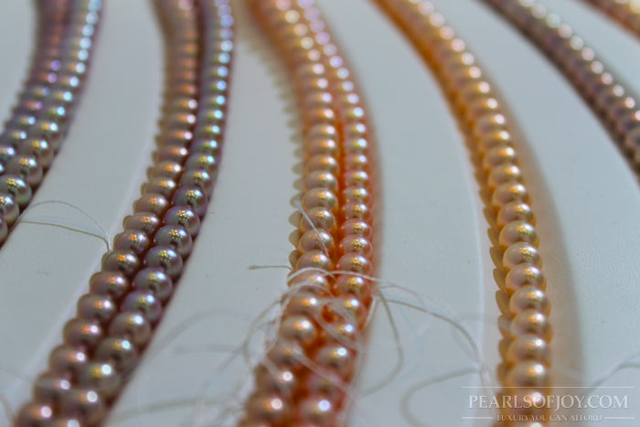 close up of strands of graduated metallic pearls