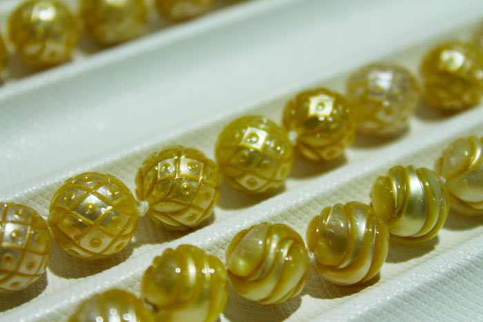 intricate patterns on the gold pearls