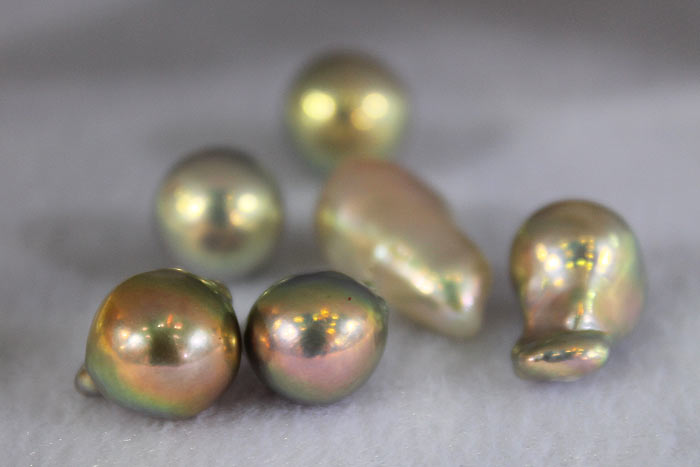 a handful of bead-nucleated gold pearls