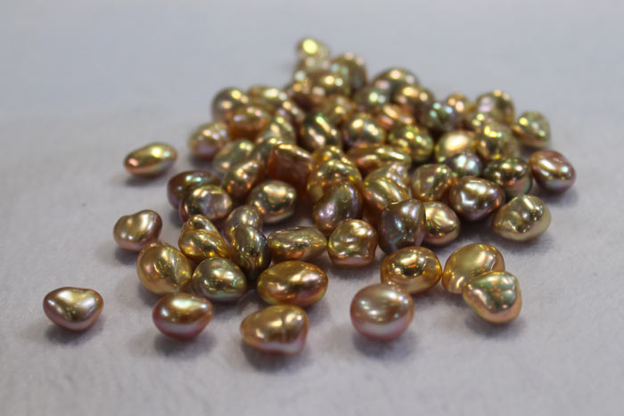 a bundle of golden free form baroque pearls