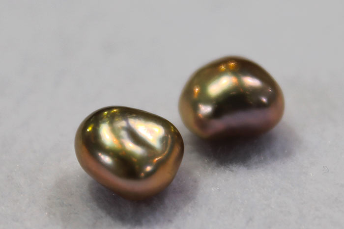 a pair of golden pearl nuggets