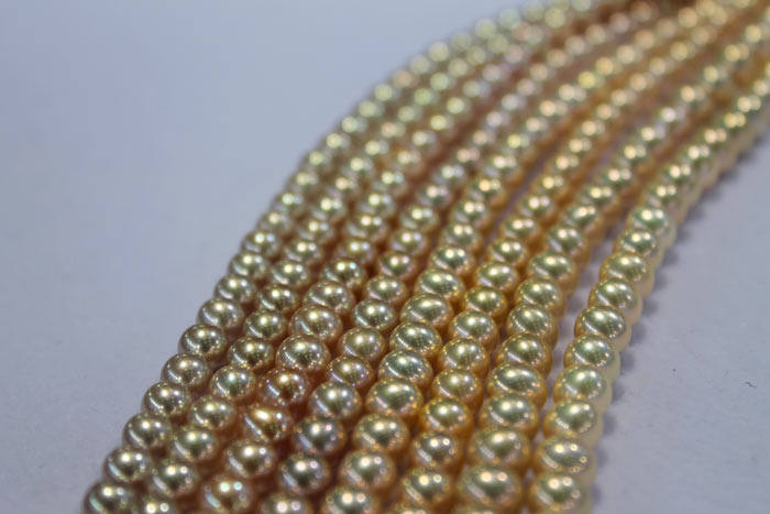 strands of different colored metallic pearls
