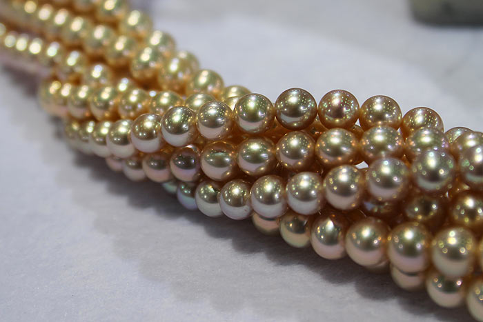 strands of golden metallic pearls