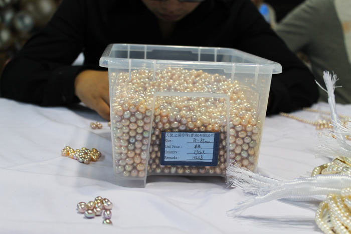 a bucket of drop-shaped pearls