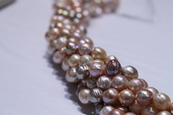 clumped strands of multicolored and peach pearls