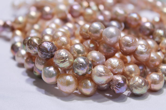 magnified image of the peach and multicolored pearls