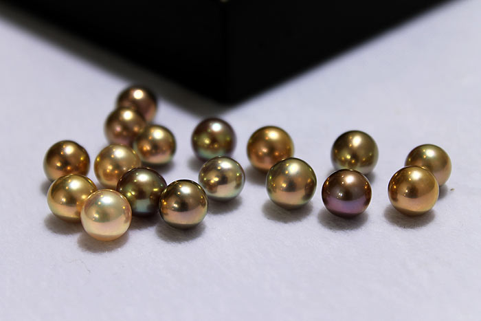 a handful of fancy colored pearls