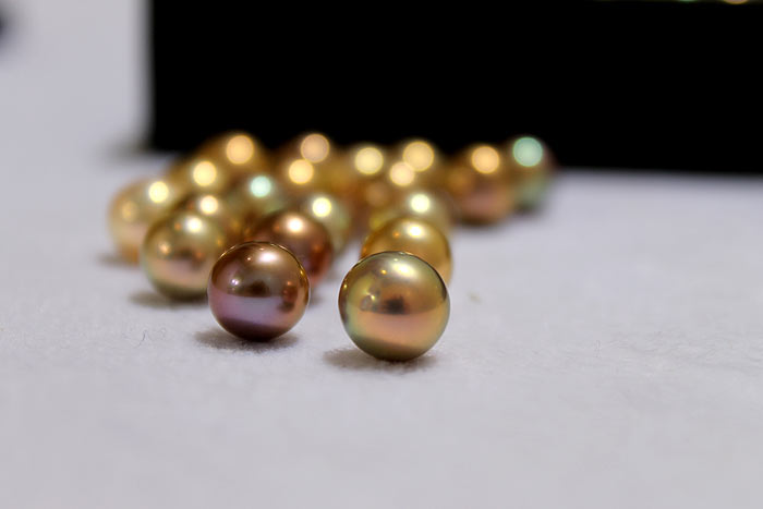 a close up of the fancy colored pearls
