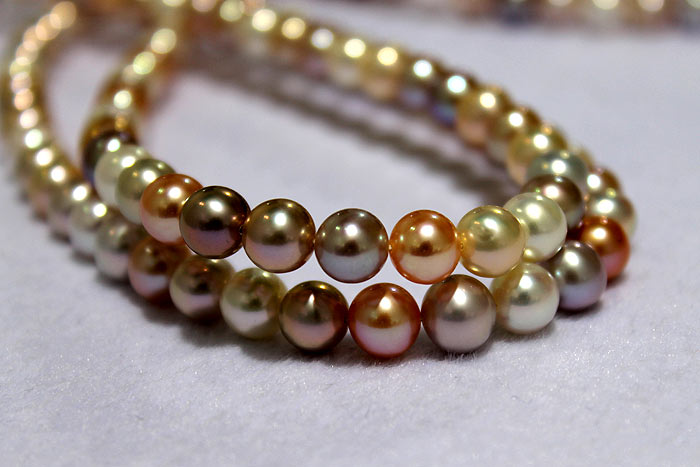 strands of round pearls with metallic luster