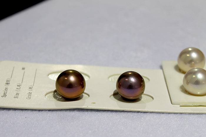white and dark purple round pearls