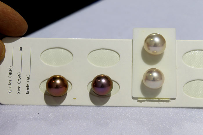 pairs of white and purple metallic round pearls