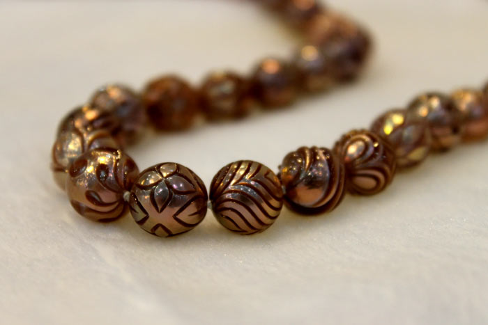 strand of Galatea pearls with different carved patterns