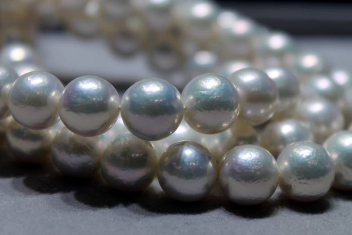 close up of white metallic pearls with ripples