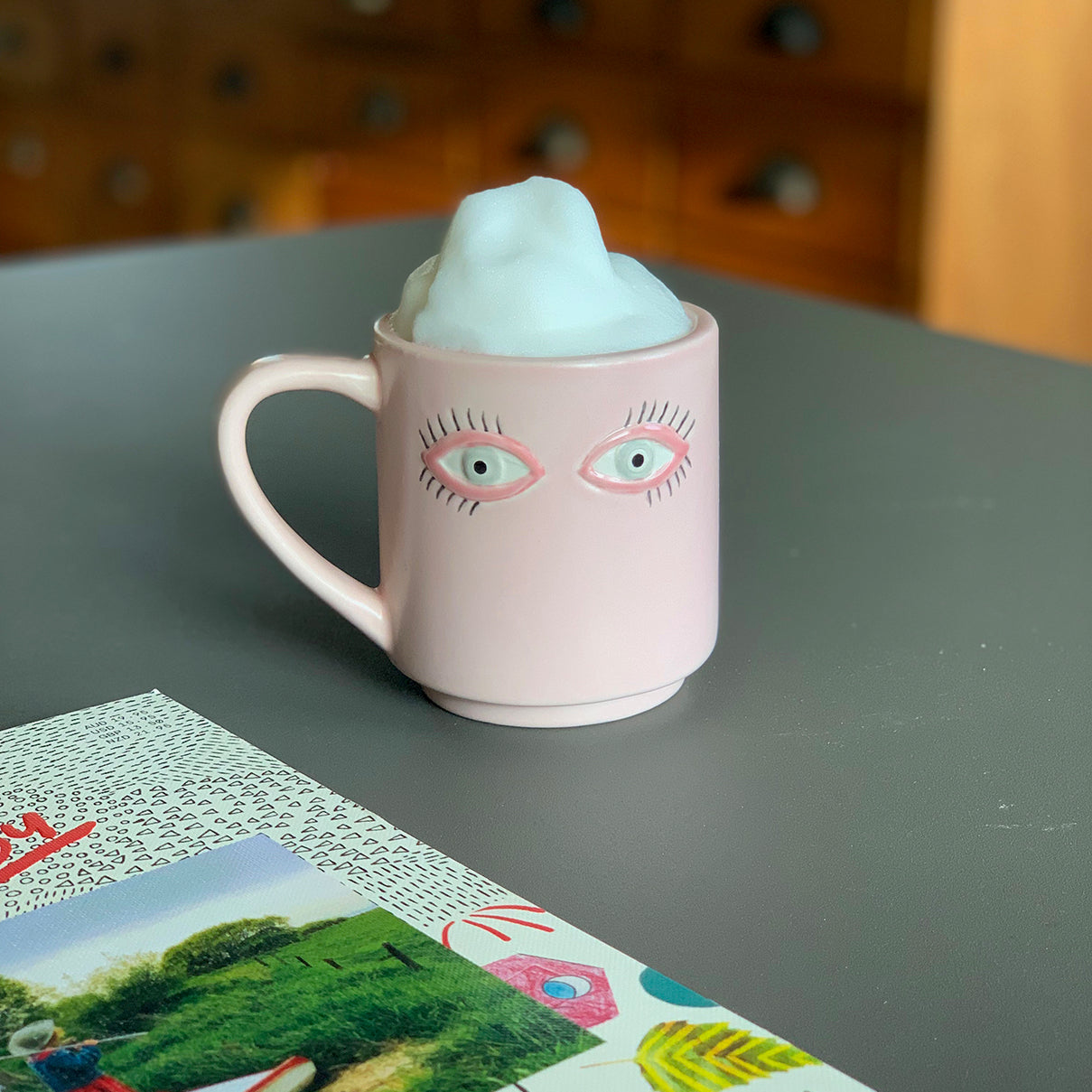 A mug with eyes drawn on by Bitten Design, from their Surreal Mug Set. 